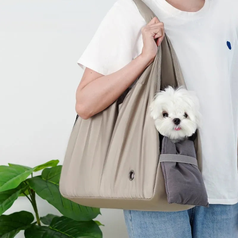Apricot-colour cloth pet carrier handbag with mesh panels and a shoulder strap.