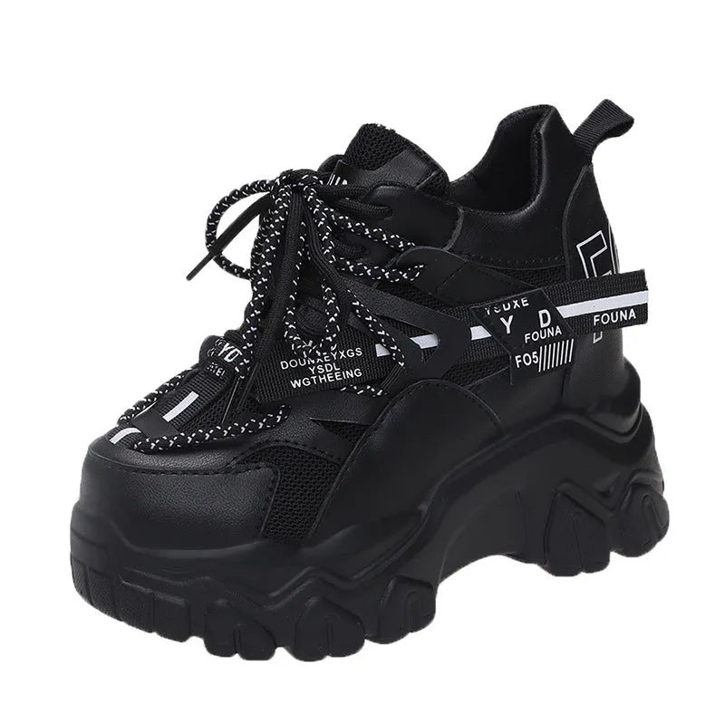 White women's low-top platform sports shoes with a cross-strap over a shallow-cut collar and a thick rubber sole.