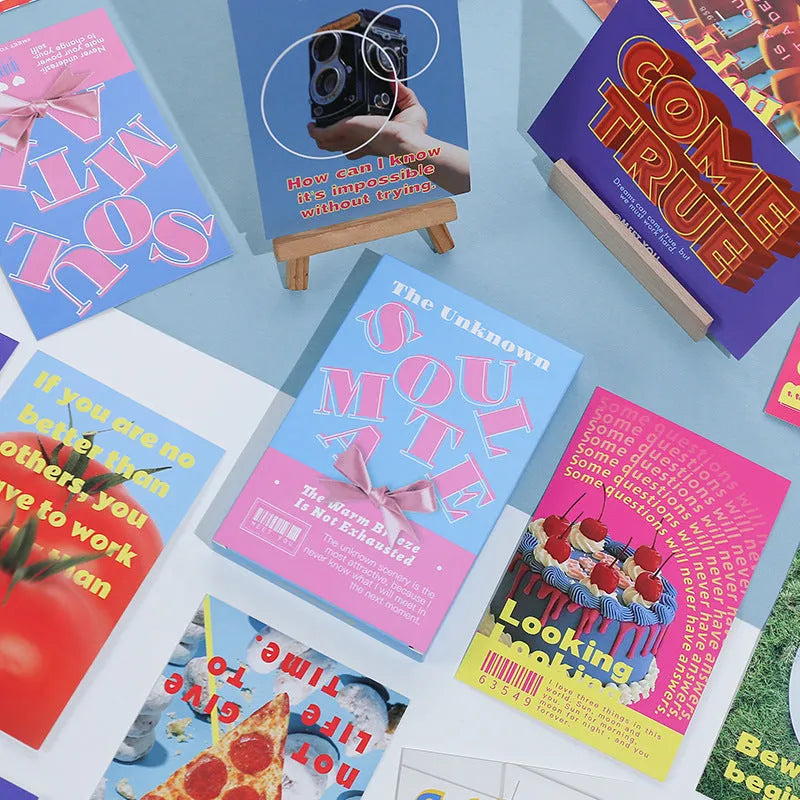 Box of fresh printed postcards showing two creative greeting card designs.