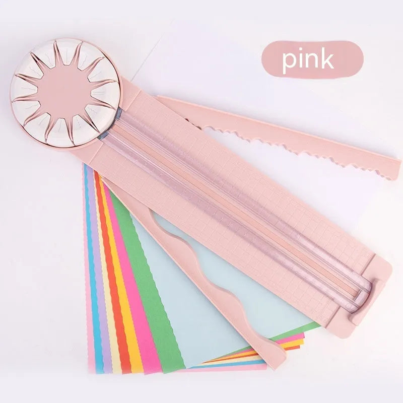 Pink plastic 12-in-1 paper cutting machine with dotted line and other pattern guides on a flat surface.