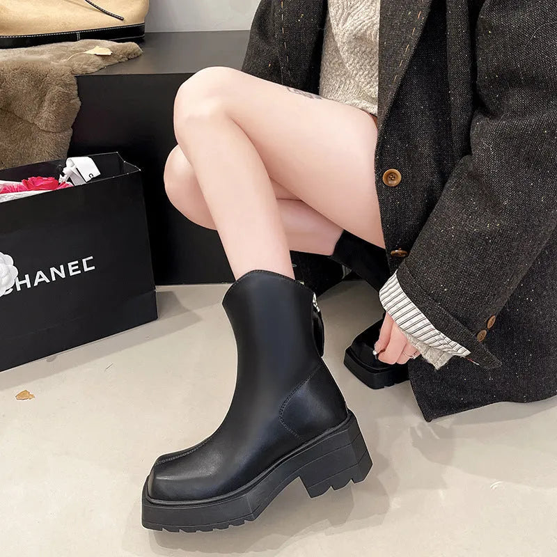 Black platform Martin boots for women with a square toe and back zipper on a rubber sole.