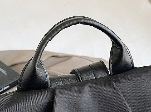 Women's black travel backpack with contrast stitching, large capacity, and three-dimensional outer pocket
