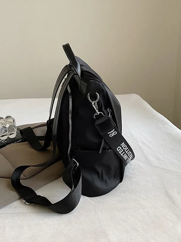 Women's black travel backpack with contrast stitching, large capacity, and three-dimensional outer pocket