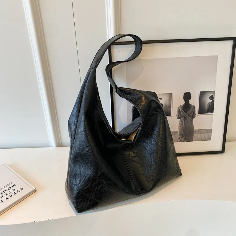Soft black PU leather women's shoulder bag with large capacity and visible sewing thread detail.