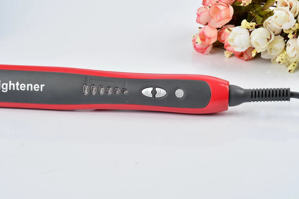 Black and red ceramic hair straightening brush with heated teeth and LED display on white background