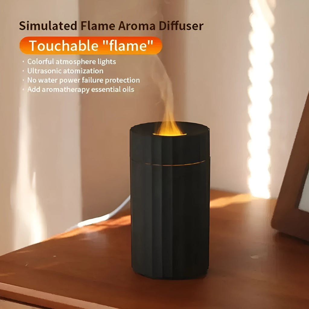 Black portable USB air humidifier and essential oil diffuser with glowing LED flame effect on a table