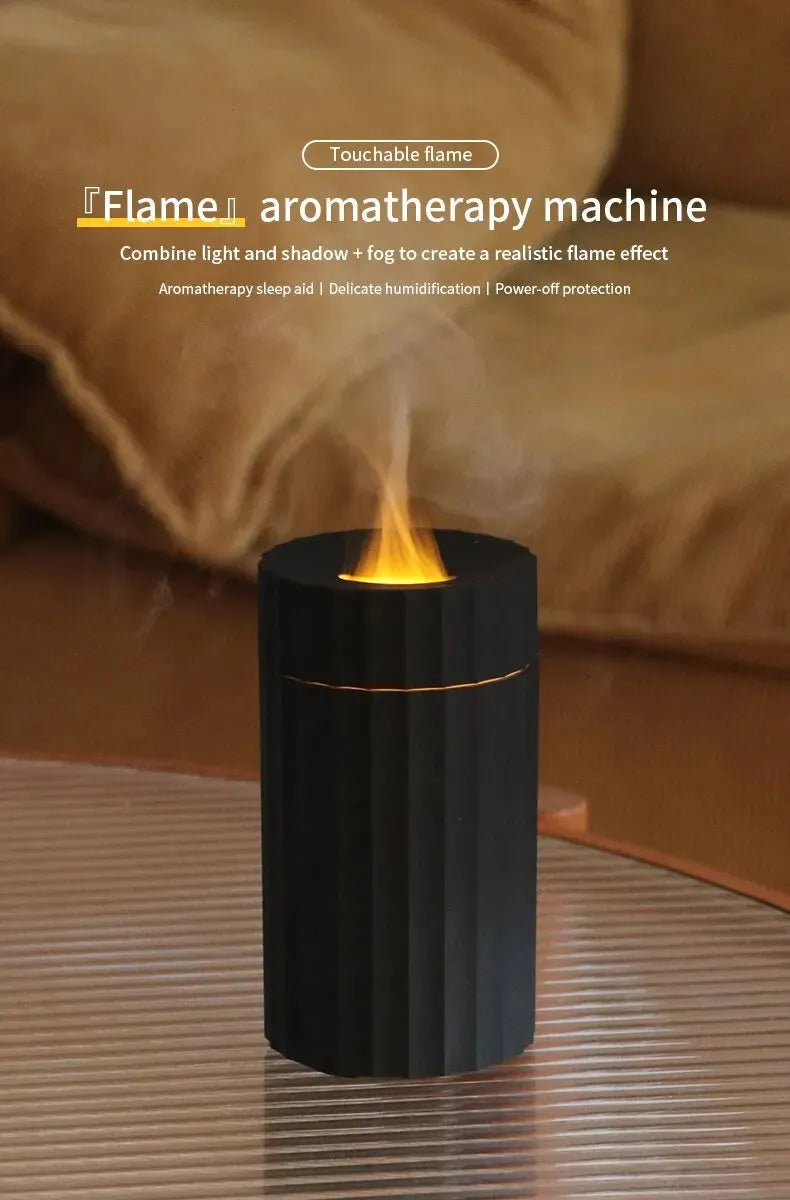 Black portable USB air humidifier and essential oil diffuser with glowing LED flame effect on a table