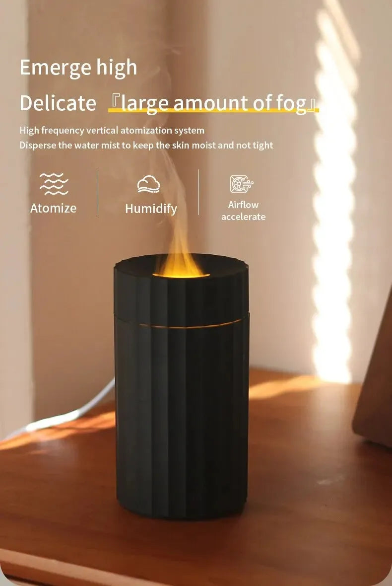 Black portable USB air humidifier and essential oil diffuser with glowing LED flame effect on a table