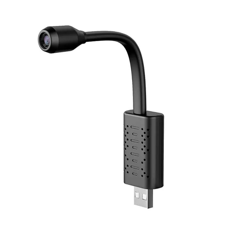 Black V380 wireless USB security camera on a wooden surface next to a microSD card and USB cable.
