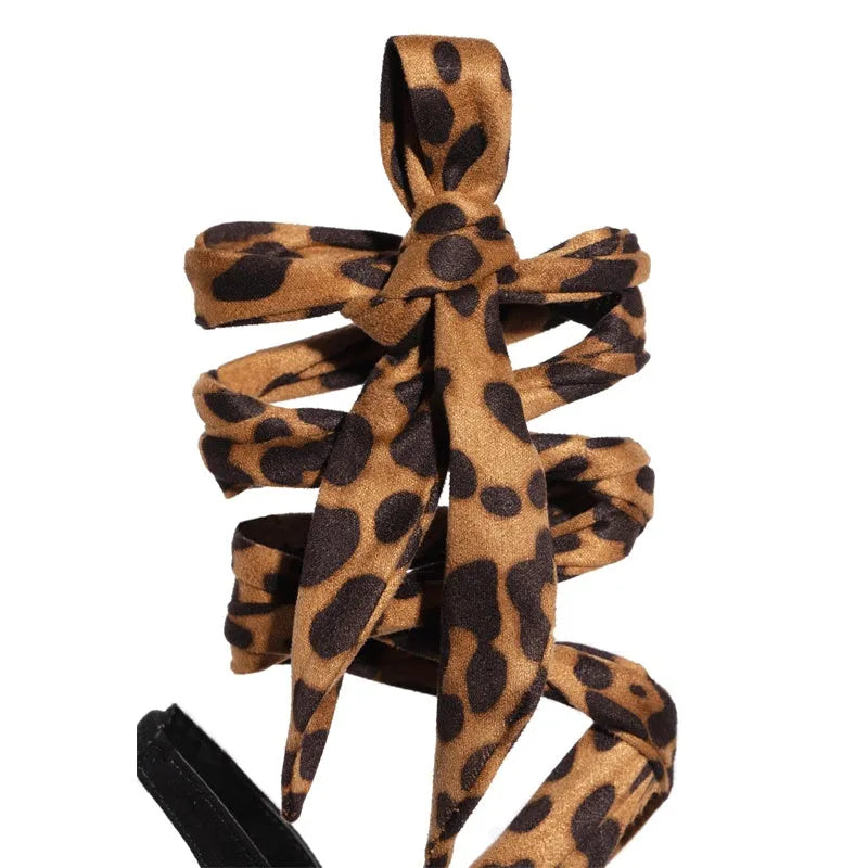 Light brown leopard print women's high-heel sandals with cross straps and an 8cm fine heel on a rubber sole.