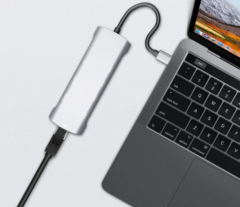 Grey aluminium USB-C docking station with 4K HDMI, VGA, and USB ports, showing 140mm attached cable.