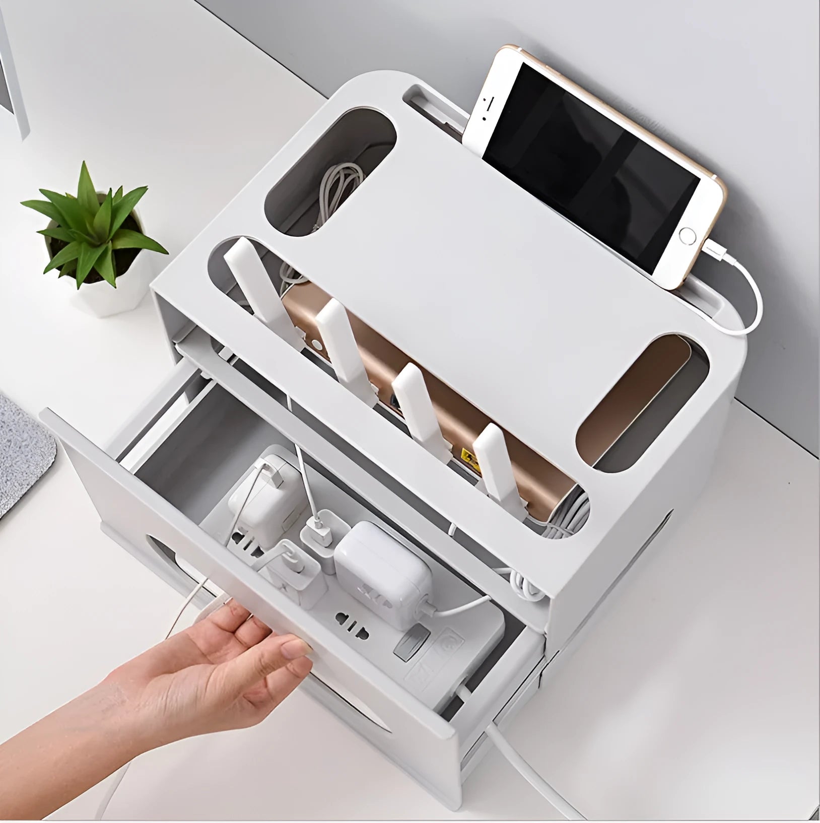 Grey and white plastic wireless router storage box with cable management holes and storage compartments