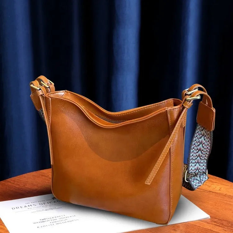 Genuine leather women's messenger bag with multiple internal compartments in black, sugar brown, golden brown, or dark green.