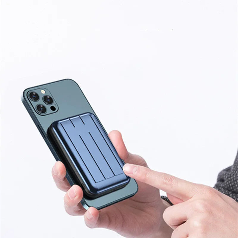 Blue magnetic mobile power bank showing wireless charging surface and USB ports with 5000mAh capacity display