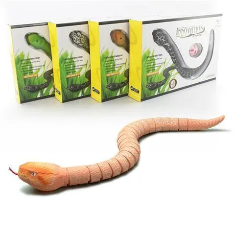 Green remote control snake toy with retractable tongue and swinging tail on floor