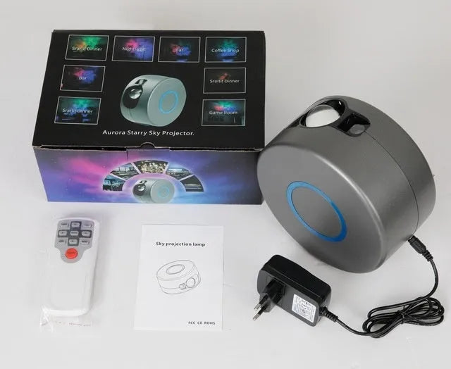 Grey starry sky projection lamp with remote control projecting coloured stars and green laser light indoors.