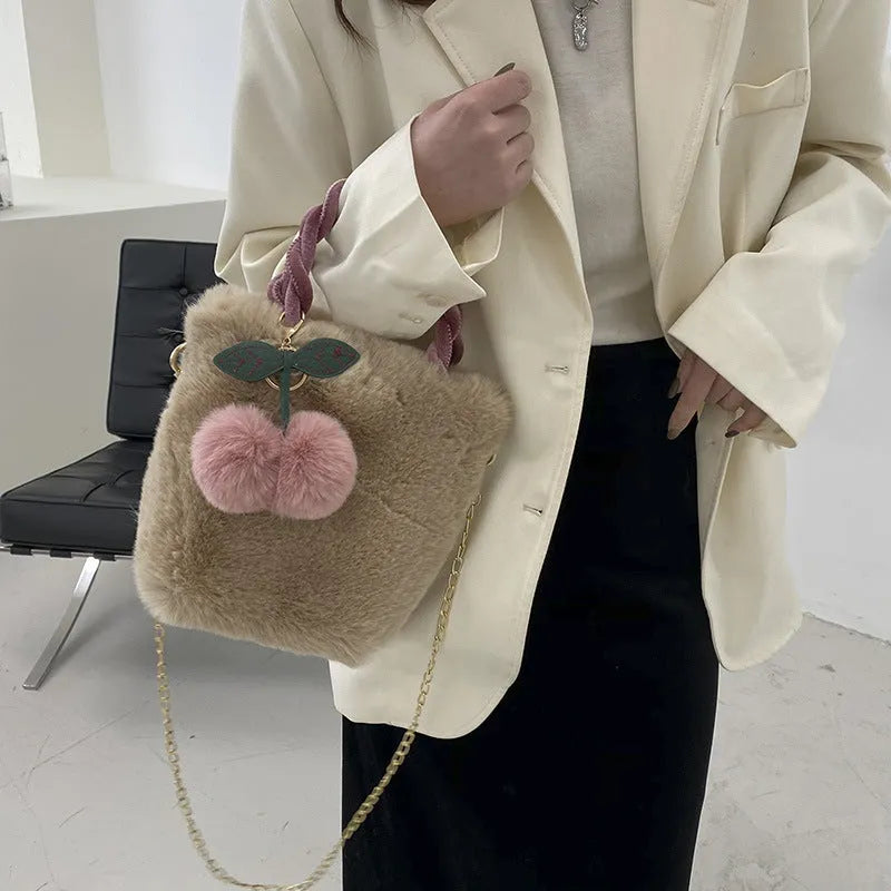 Large capacity soft plush bucket bag in beige with open outer pocket and single shoulder strap