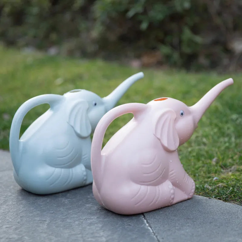 Pink baby elephant shaped plastic watering can with a long spout and bottle-style handle.