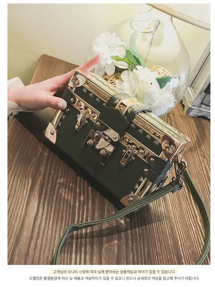 Women's black or green hard flap top shoulder bag made of PU leather with rivet details.