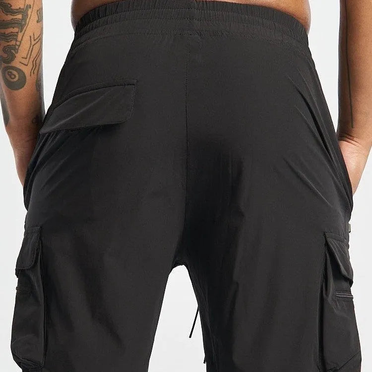 Men's black sports shorts with four-way stretch fabric and quick-dry lining for athletic activities