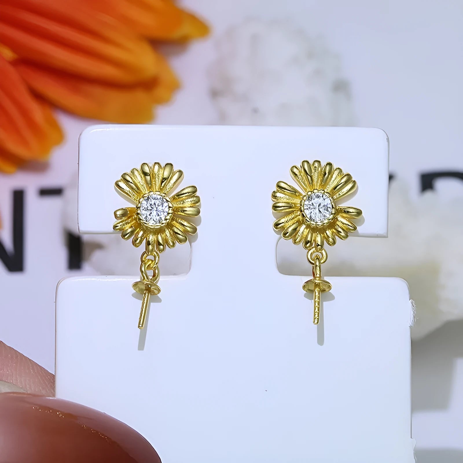A pair of baroque-style flower drop earrings with intricate openwork, made from 925 sterling silver on a plain background.