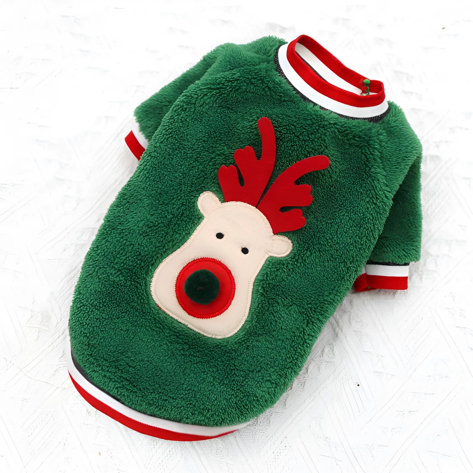 Red coral fleece dog sweater with reindeer hoodie on a small dog over a festive background
