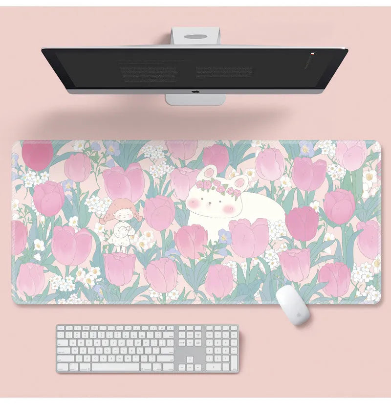 Large colourful flower pattern mouse pad on a wooden desk with keyboard and mouse.