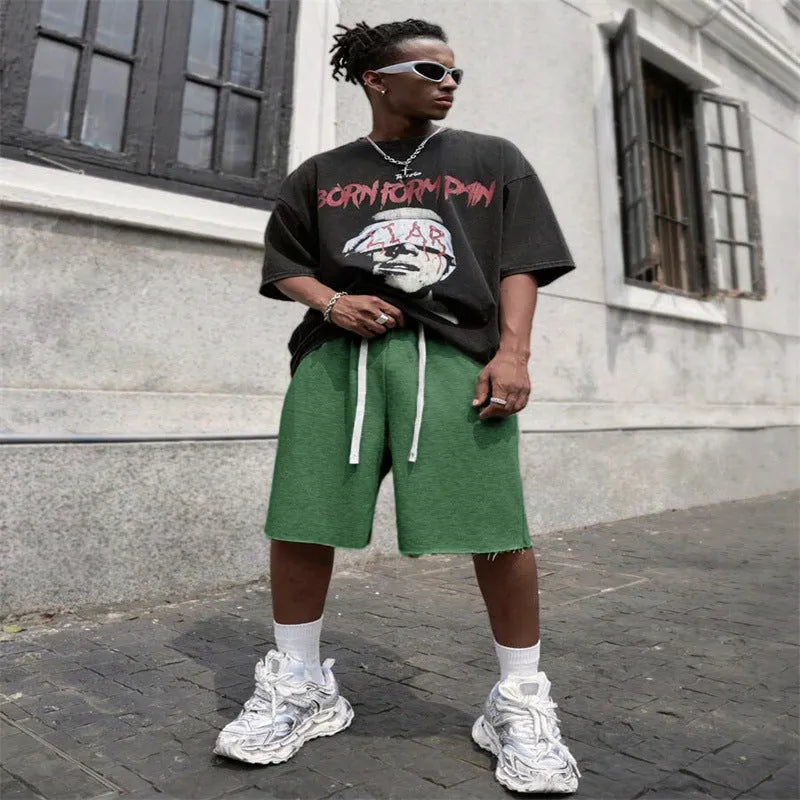 Men's straight-leg track trousers in black, shown in a casual streetwear style.