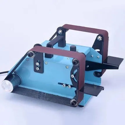 Blue desktop dual-axis belt sander with two sanding heads and a variable speed switch, shown on a workshop bench.