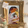 Orange yellow soft gel iPhone case with hand-drawn line art cartoon design.