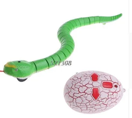 Green remote control snake toy with retractable tongue and swinging tail on floor