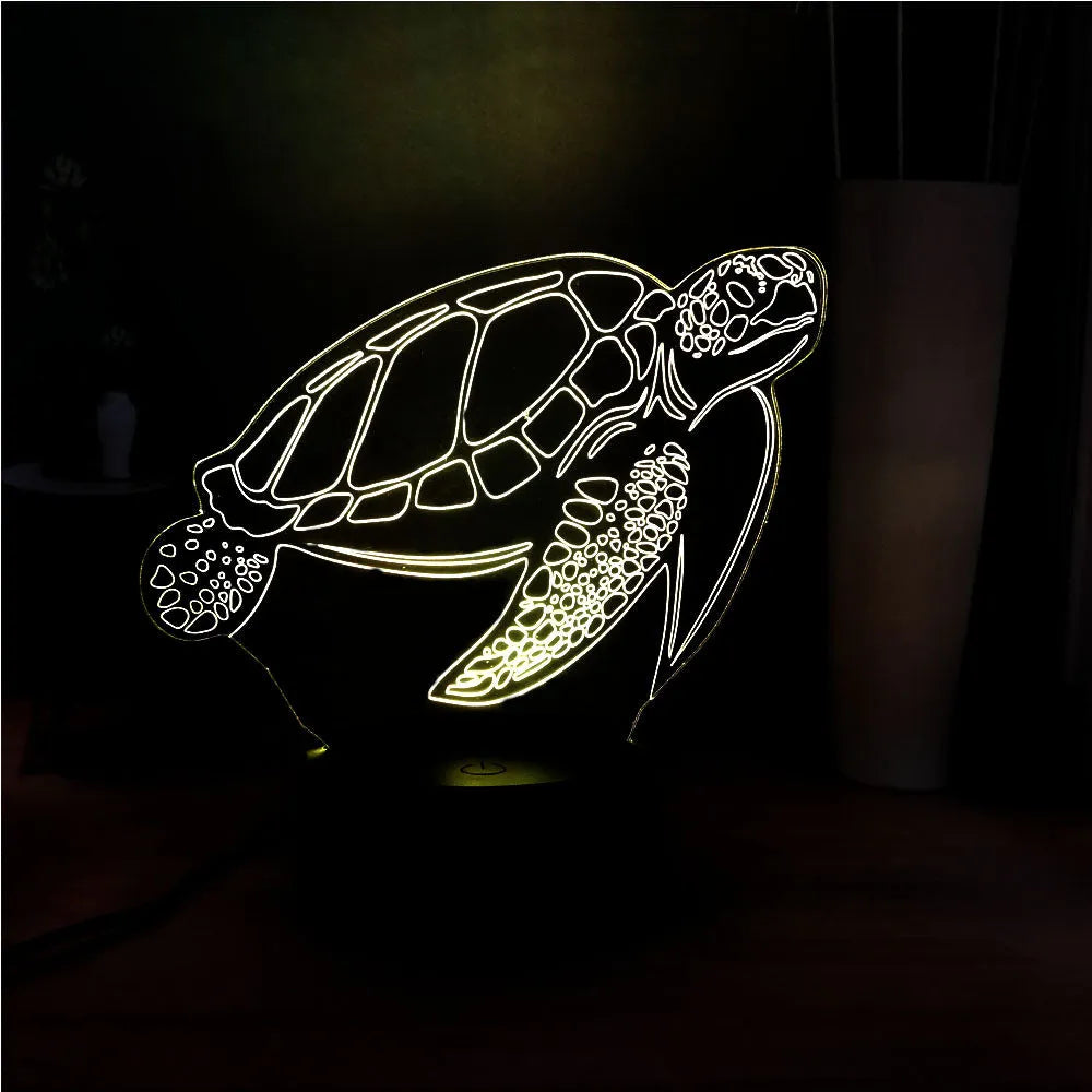 3D acrylic turtle-shaped LED night light with remote control on a bedside table.