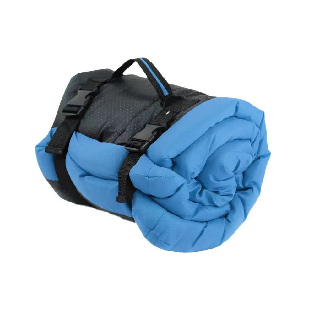 Blue foldable waterproof dog bed shown both open and folded with nylon buckles, on grass.