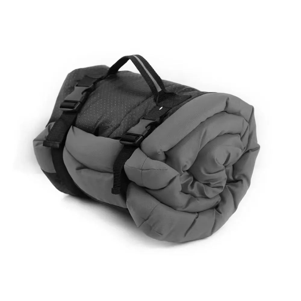 Blue foldable waterproof dog bed shown both open and folded with nylon buckles, on grass.