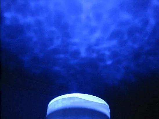 Blue ceiling-mounted ocean projection lamp showing a 2D vertical movie effect on a wall.