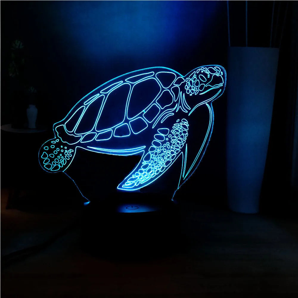 3D acrylic turtle-shaped LED night light with remote control on a bedside table.
