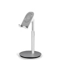 Silver metal computer phone holder stand for smartphones and tablets on a desktop.