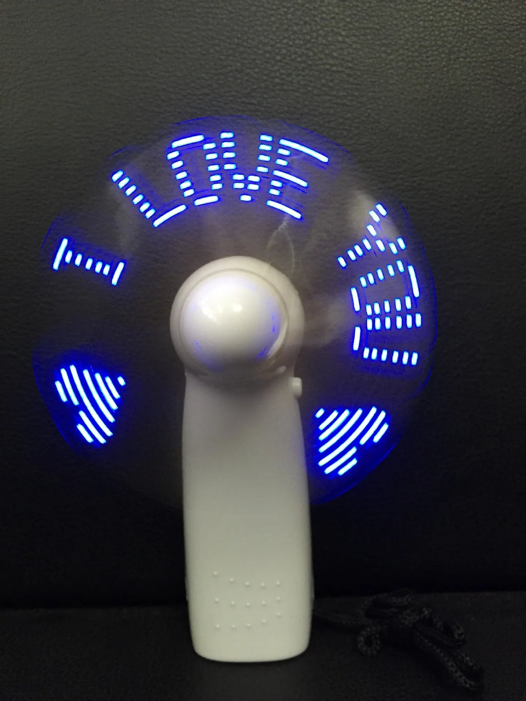 White handheld mini fan with flashing blue I Love You LED display, showing dimensions.