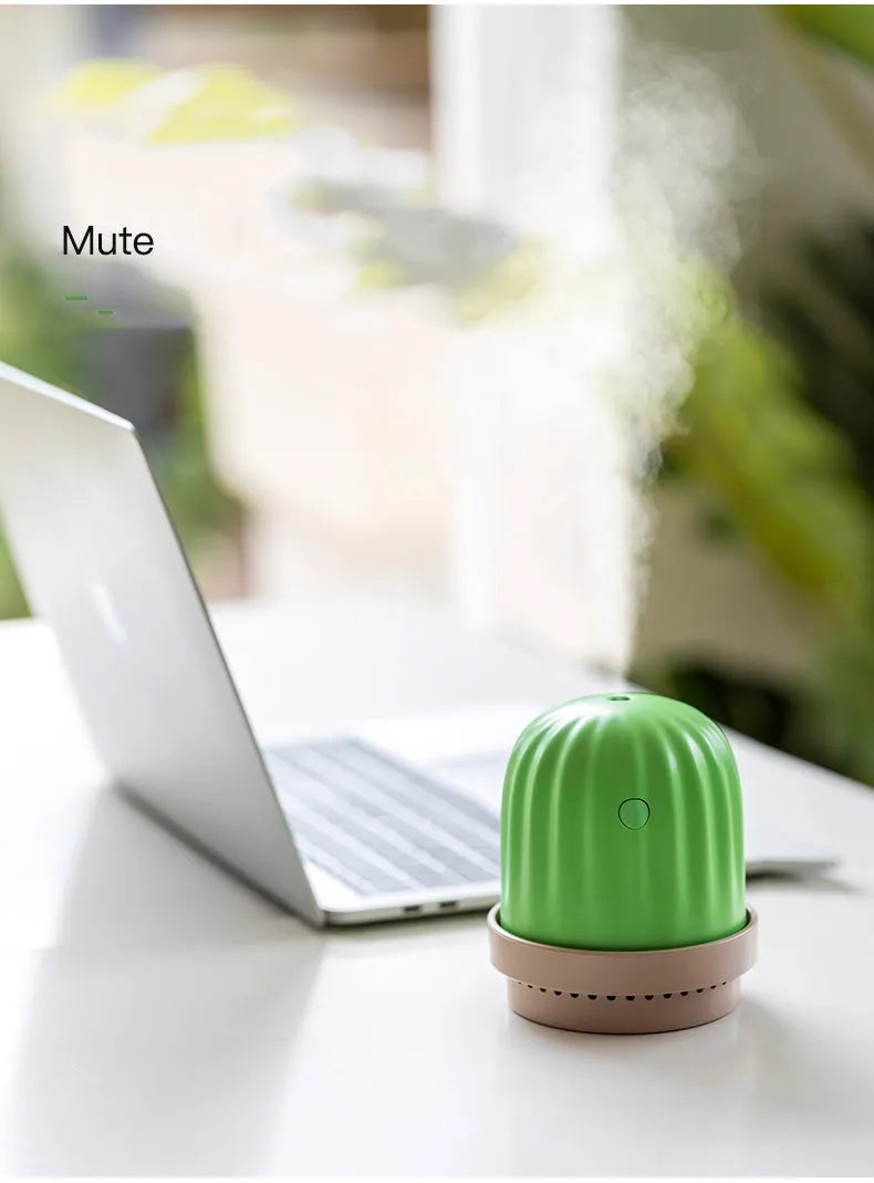 Cactus humidifier night light in green with colourful LED glow on a wooden desk