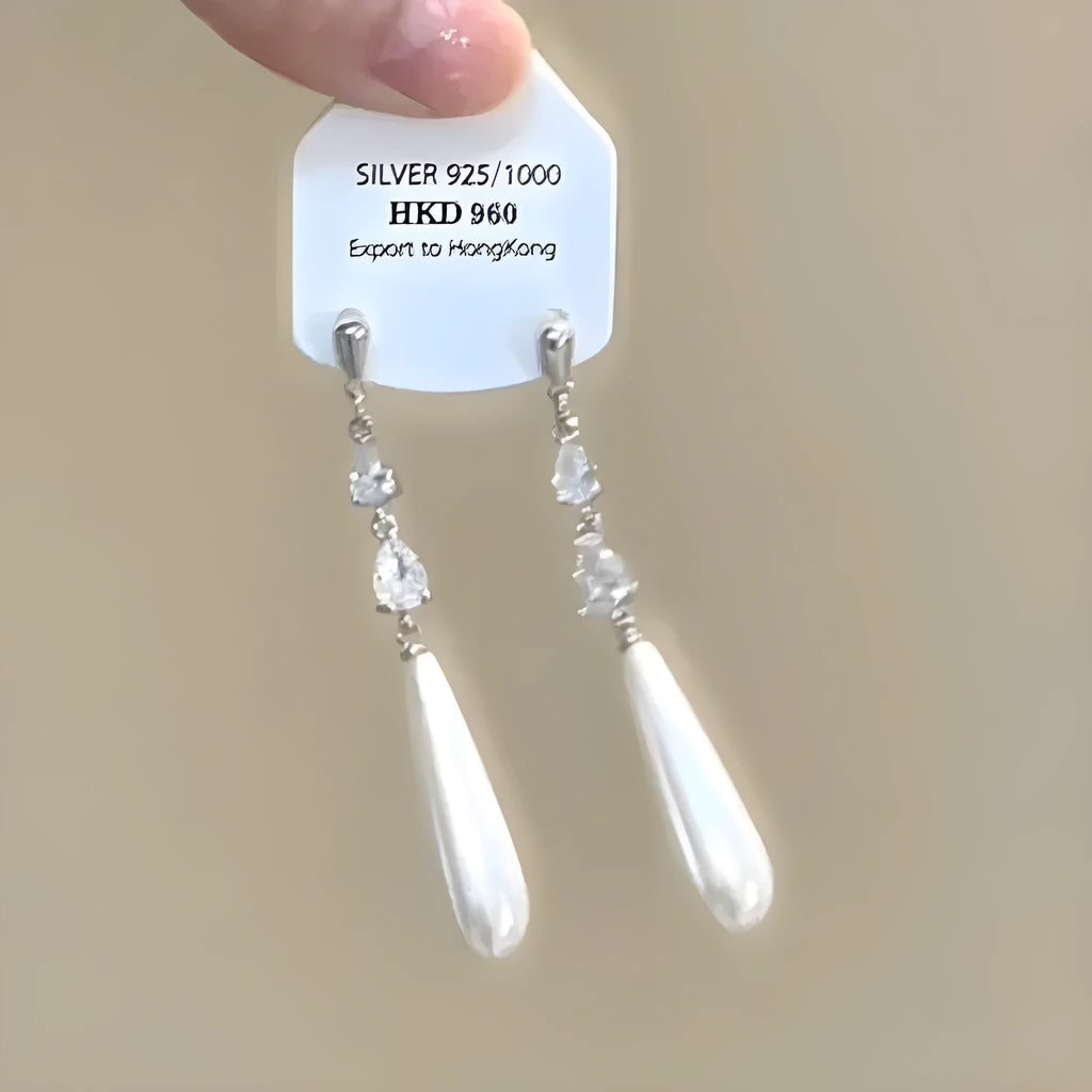 Close-up of women's geometric star tassel earrings with full rhinestone cover, showing stud and clip-on fastening options.
