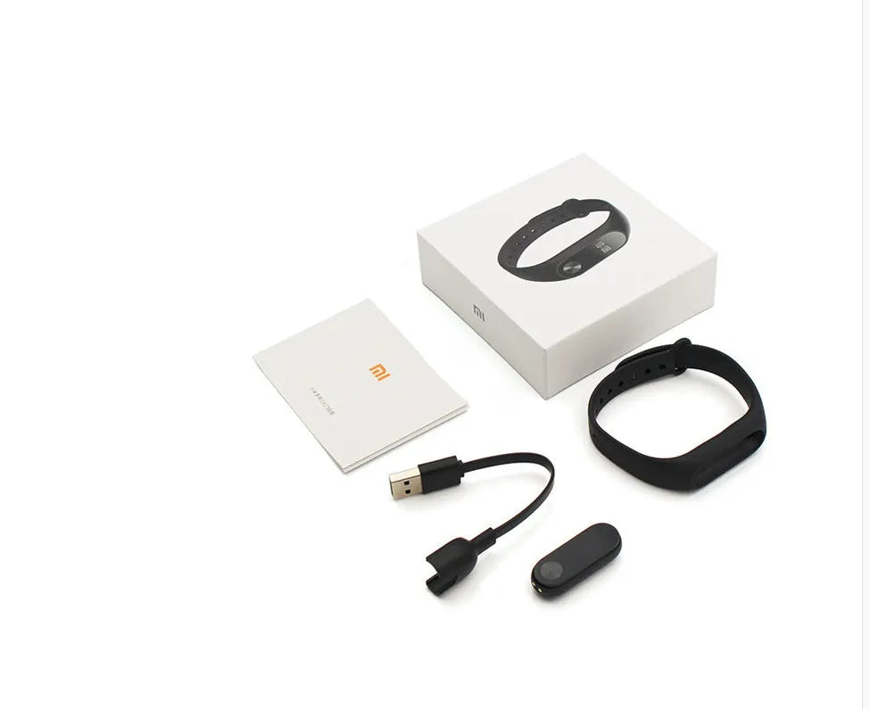 Xiaomi Mi Band 2 black fitness tracker with OLED screen on a wrist.
