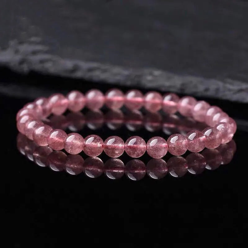 Women's strawberry quartz crystal bracelet with polished beads in 6mm, 8mm, and 10mm sizes