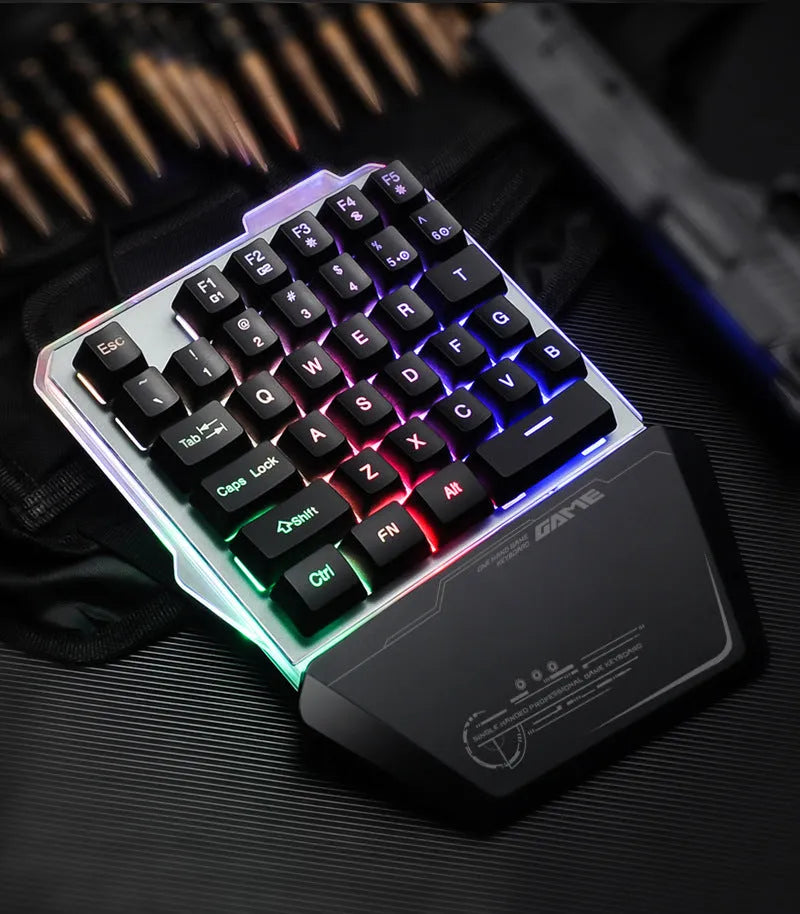 Black G40 Flow one-handed mechanical keyboard with RGB backlit keys on a desk.