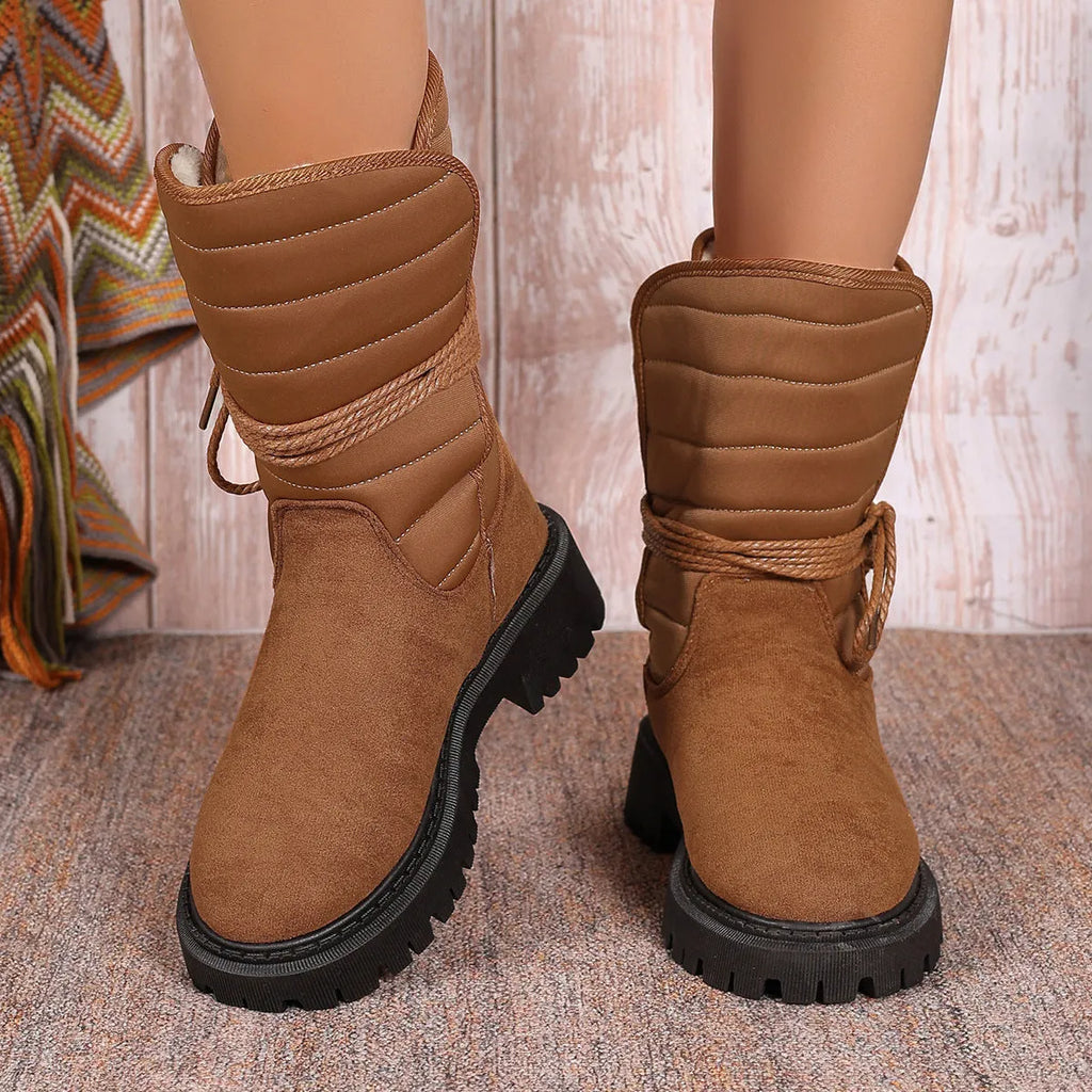 Women's black suède chunky heel snow boots with lace-up design and fleece lining.
