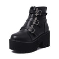 Black women's punk ankle boots with metal bat buckle and thick platform sole.