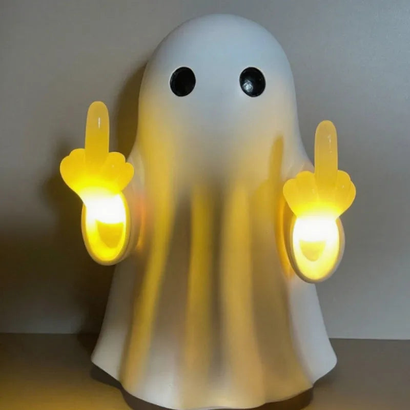White plastic ghost statue night lamp for Halloween decoration on a dark surface.