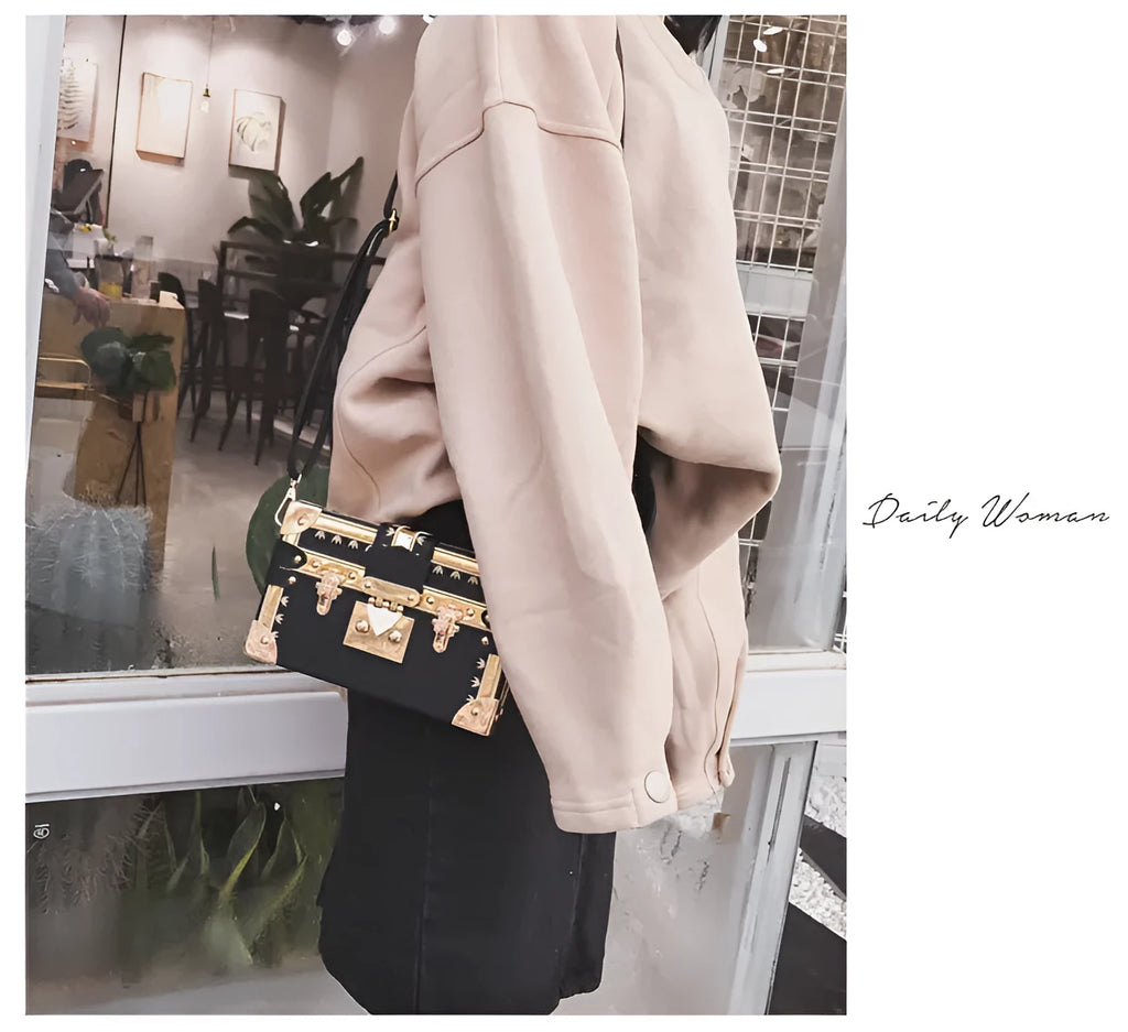 Women's black or green hard flap top shoulder bag made of PU leather with rivet details.
