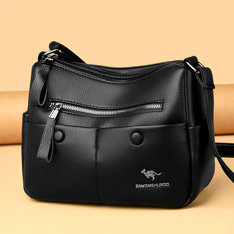 Soft black PU leather women's crossbody bag showing external pockets and a horizontal square shape.