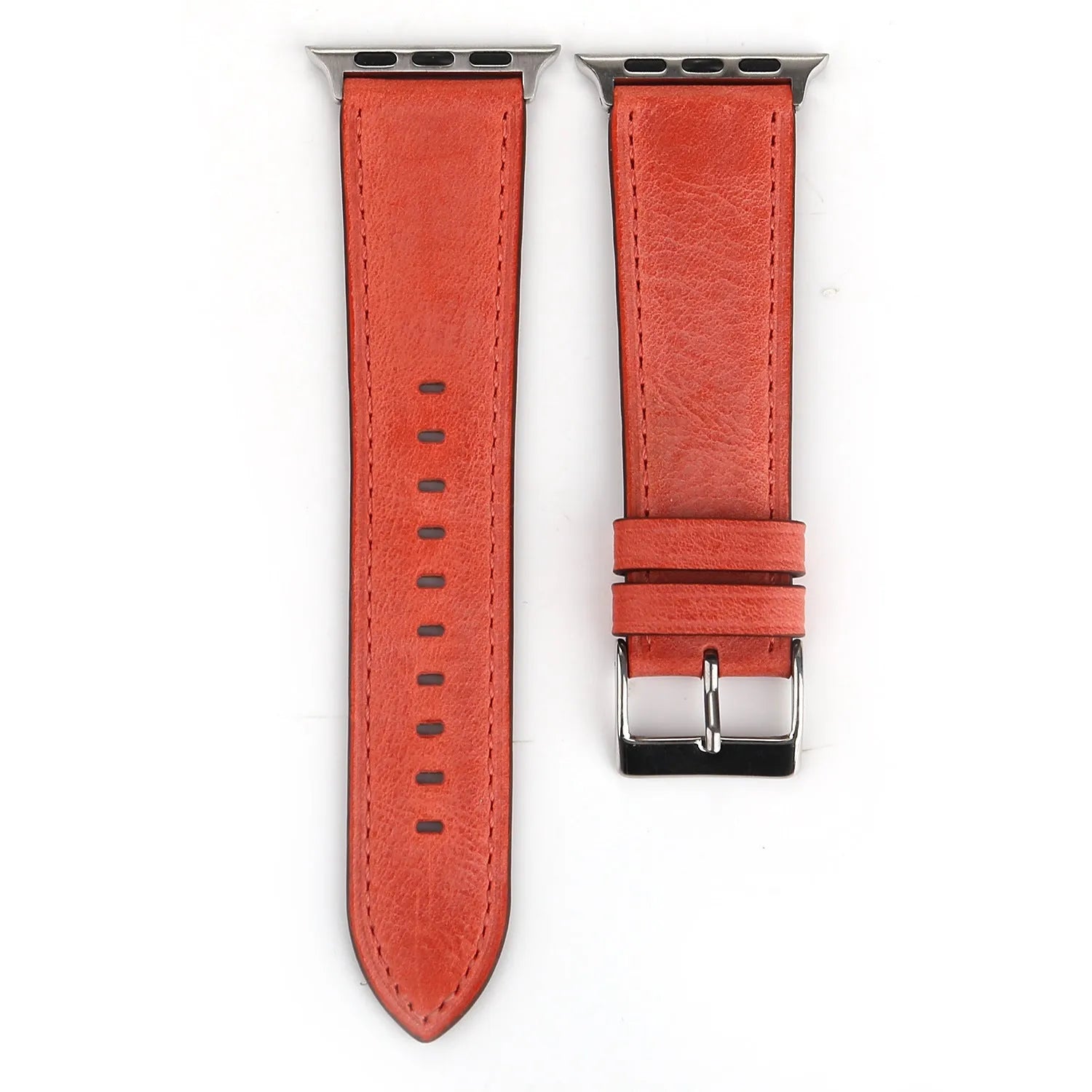 Leather watch strap with a metal folding buckle on a wooden surface.