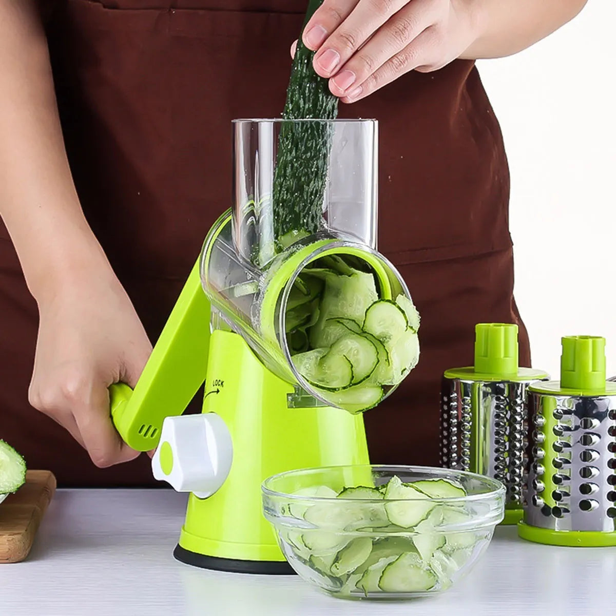 Mandoline vegetable slicer with three stainless steel blades and suction base in blue green, green, or red